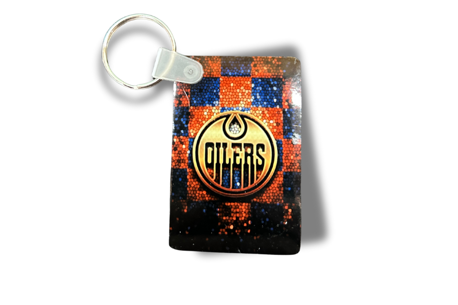 Keychain with Oilers logo on a checkered background
